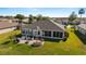 Charming backyard featuring a patio with outdoor seating, a grill, and a well-manicured lawn at 2380 Nw 55Th Avenue Rd, Ocala, FL 34482