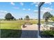 The backyard boasts a well-kept lawn and a patio with white Adirondack chairs at 2380 Nw 55Th Avenue Rd, Ocala, FL 34482