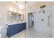 Bathroom with glass shower, marble vanity with double sinks, chandelier, and geometric tile at 2380 Nw 55Th Avenue Rd, Ocala, FL 34482