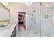 Bright bathroom featuring glass shower, double marble vanity, chandelier and patterned flooring at 2380 Nw 55Th Avenue Rd, Ocala, FL 34482