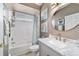 Bright bathroom featuring a shower tub combination, white vanity with marble top, and coastal decor at 2380 Nw 55Th Avenue Rd, Ocala, FL 34482