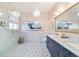Bathroom with elegant chandelier, gray double vanity with marble top, and beautiful patterned tile at 2380 Nw 55Th Avenue Rd, Ocala, FL 34482