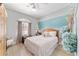 Comfortable bedroom with light wood floors, a ceiling fan, and a mural wall at 2380 Nw 55Th Avenue Rd, Ocala, FL 34482