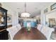 Dining area with elegant chandelier and views of the open kitchen at 2380 Nw 55Th Avenue Rd, Ocala, FL 34482