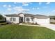 Charming single-story home with manicured lawn and inviting front yard seating area at 2380 Nw 55Th Avenue Rd, Ocala, FL 34482