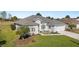 Charming home exterior with a well-manicured lawn, a two-car garage, and colorful landscaping at 2380 Nw 55Th Avenue Rd, Ocala, FL 34482