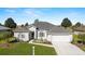 Beautiful home exterior with well-manicured lawn, landscaping, a two-car garage and nice front porch at 2380 Nw 55Th Avenue Rd, Ocala, FL 34482