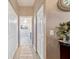 Hallway view to bathroom with patterned tile, neutral color, walk in closets and white painted doors at 2380 Nw 55Th Avenue Rd, Ocala, FL 34482