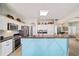 Open kitchen featuring stainless appliances, breakfast bar and light wood flooring at 2380 Nw 55Th Avenue Rd, Ocala, FL 34482
