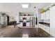 Modern kitchen featuring stainless steel appliances, granite countertops and white cabinets with decor on top at 2380 Nw 55Th Avenue Rd, Ocala, FL 34482