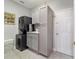 Functional laundry room with stackable washer and dryer, built-in cabinets at 2380 Nw 55Th Avenue Rd, Ocala, FL 34482