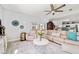 Bright living room featuring a ceiling fan, comfortable seating, and sliding glass doors at 2380 Nw 55Th Avenue Rd, Ocala, FL 34482