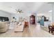 Open-concept living room with wood floors, ceiling fan, and plenty of natural light at 2380 Nw 55Th Avenue Rd, Ocala, FL 34482
