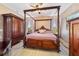 Spacious main bedroom with a poster bed, wood flooring, and decorative wood furnishings at 2380 Nw 55Th Avenue Rd, Ocala, FL 34482