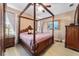 Main bedroom featuring a poster bed, neutral walls, wood flooring and a ceiling fan at 2380 Nw 55Th Avenue Rd, Ocala, FL 34482
