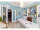 Bright office features built-in cabinets, a stylish desk, and French doors to hallway at 2380 Nw 55Th Avenue Rd, Ocala, FL 34482