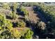 Bird's eye view of a property's long, winding driveway through an expansive wooded lot at 2570 Se Highway 42, Summerfield, FL 34491