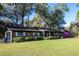 Charming brick home with a well-maintained lawn and mature trees offering shade and curb appeal at 2570 Se Highway 42, Summerfield, FL 34491
