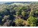 Aerial of secluded property with an estate home nestled among the trees and an open yard at 2570 Se Highway 42, Summerfield, FL 34491