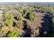 Aerial shot of a partially cleared property surrounded by lush trees and natural landscape at 2570 Se Highway 42, Summerfield, FL 34491