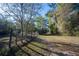 A fenced, grass-covered expanse bordered by trees, offering a versatile outdoor area for recreation or development at 2570 Se Highway 42, Summerfield, FL 34491