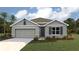 Charming single-story home featuring a two-car garage, well-manicured lawn and tropical landscaping at 31 Hickory Crse, Ocala, FL 34472