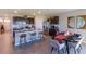 Spacious kitchen and dining area featuring dark cabinets, stainless steel appliances and island seating at 31 Hickory Crse, Ocala, FL 34472