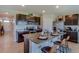 Modern kitchen featuring a granite island with seating, stainless steel appliances and beautiful dark cabinetry at 31 Hickory Crse, Ocala, FL 34472