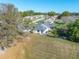 Aerial view showing the roof, yard, trees, and the screened-in porch of the home and neighborhood at 3275 Nw 44Th Ct, Ocala, FL 34482