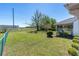 Spacious backyard features a well-maintained lawn, screened-in porch with chairs, and lush greenery at 3275 Nw 44Th Ct, Ocala, FL 34482