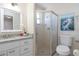 Bathroom featuring a shower, toilet, mirror and vanity with stone countertop at 3275 Nw 44Th Ct, Ocala, FL 34482