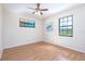 Bright bedroom with hardwood floors, ceiling fan, and natural light from two windows at 3275 Nw 44Th Ct, Ocala, FL 34482