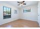Bedroom with wood floors, ceiling fan, and views of the front yard at 3275 Nw 44Th Ct, Ocala, FL 34482