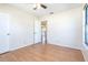 Bedroom with wood floors, ceiling fan, and views to the kitchen at 3275 Nw 44Th Ct, Ocala, FL 34482