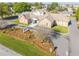Aerial view of the community clubhouse featuring the landscaped entry, flagpole, and parking area at 3275 Nw 44Th Ct, Ocala, FL 34482