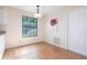Bright dining room with wood floors, modern lighting, and view to outdoors at 3275 Nw 44Th Ct, Ocala, FL 34482
