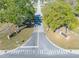 Aerial view of the community entrance showing the signage, trees, road and crosswalk at 3275 Nw 44Th Ct, Ocala, FL 34482
