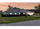 Charming single-story home featuring a well-manicured lawn and beautiful sunset sky at 3275 Nw 44Th Ct, Ocala, FL 34482