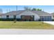 Well-maintained single-story home with a two-car garage, lawn, and manicured landscaping at 3275 Nw 44Th Ct, Ocala, FL 34482