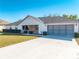 Charming single-story home with a two-car garage, concrete driveway and manicured landscaping at 3275 Nw 44Th Ct, Ocala, FL 34482