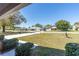 Spacious front yard with mature trees and shrubs and a concrete driveway at 3275 Nw 44Th Ct, Ocala, FL 34482