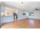 Open-concept living and dining area with wood floors, bar seating, and modern appliances at 3275 Nw 44Th Ct, Ocala, FL 34482