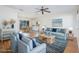 Bright living room with blue accents, ceiling fan, and hardwood floors leading to dining area at 3275 Nw 44Th Ct, Ocala, FL 34482