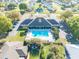 Aerial view of the community pool area with an inviting swimming pool, clubhouse, and ample parking at 3275 Nw 44Th Ct, Ocala, FL 34482