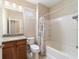 The full bathroom features a tub with a shower and a vanity with a granite countertop at 3935 Nw 46Th Ter, Ocala, FL 34482