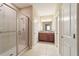 Bathroom with glass-enclosed shower, tile floors, and dual sinks at 3935 Nw 46Th Ter, Ocala, FL 34482