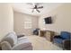 Cozy room features a ceiling fan, a window, a desk, a couch, and 2 chairs at 3935 Nw 46Th Ter, Ocala, FL 34482