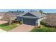 Charming single-Gathering home with a two-car garage, manicured landscaping, and a brick paver driveway at 3935 Nw 46Th Ter, Ocala, FL 34482