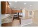 A modern kitchen features stainless steel appliances, granite counters, and a breakfast bar at 3935 Nw 46Th Ter, Ocala, FL 34482