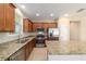 A modern kitchen features stainless steel appliances, granite counters, and a sink under a window at 3935 Nw 46Th Ter, Ocala, FL 34482